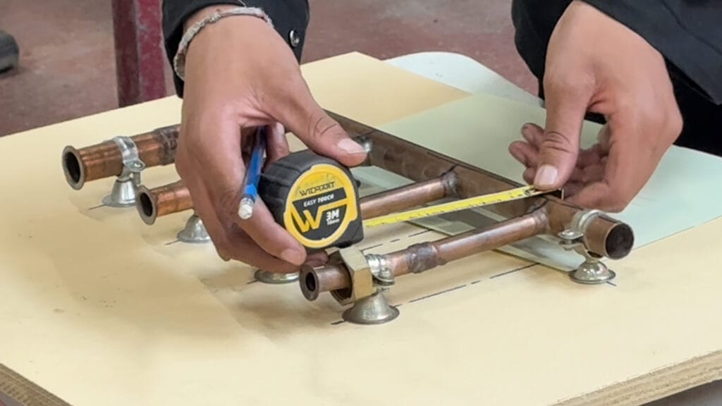 a person measuring a pipe