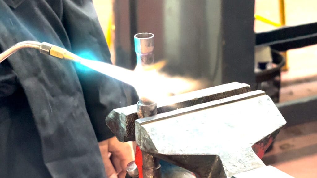 a student using a metal pipe