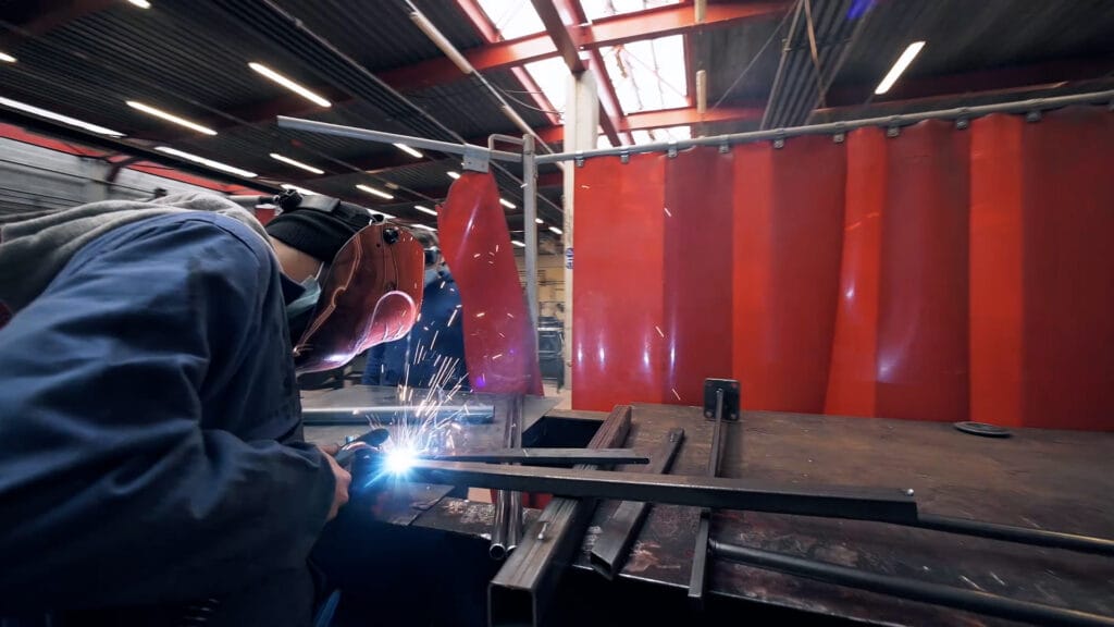 a student welding a piece of metal